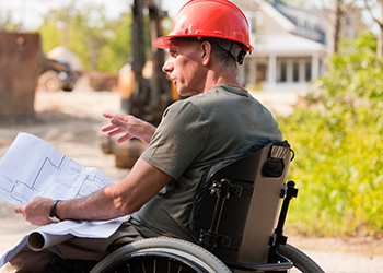 Construction workers working and viewing plans on a digital tablet