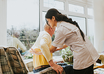 Woman helping elderly woman