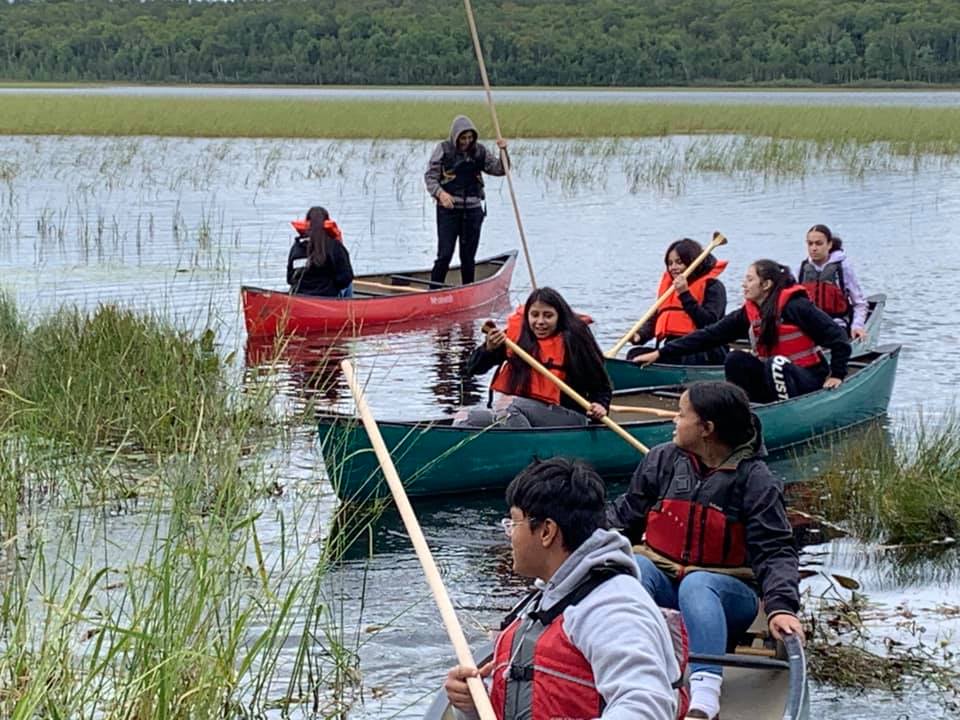 kids in canoes ricing