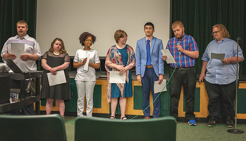 Graduates from the 2022 Ascension Mercy Medical Center Project SEARCH class give a group presentation during their graduation ceremony at Oshkosh North High School. Left to right: Ryan Delfosse, Ellie Freid, Aline Havyarimana, Isabella Jolin, Ryan Moon, Nicholas Pettibone, Richard Stickney