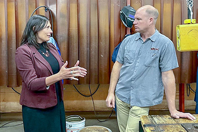 Department of Workforce Development Deputy Secretary Pam McGillivray and Kenny Skar, owner of Vincent Tool, at Menomonie High School.