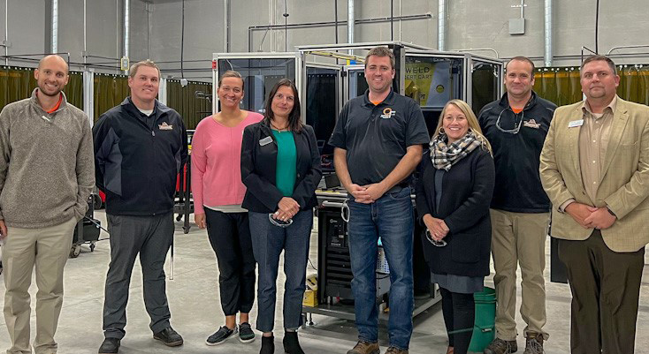 Osseo-Fairchild High School and Chippewa Valley Technical College officials in the district's new technical education center, which focuses on manufacturing, automotive and construction education. In the center is Department of Workforce Development Deputy Secretary Pamela McGillivray, who got a first-hand look at the center during Manufacturing Month as part of a statewide tour.
