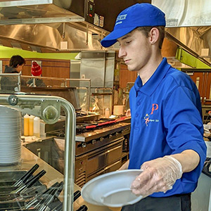 Gavin Pelfrey working in a UW-Platteville cafeteria as part a Project SEARCH internship rotation