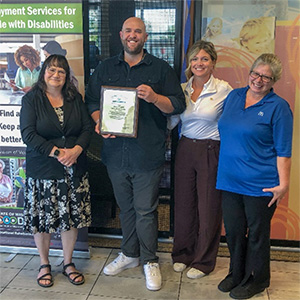 DVR Administrator Delora Newton, left, presents SKCO McDonald's Owners Sean and Kate Kennedy and Area Manger Sandy Bernard, right, with Gov. Evers' Exemplary Employer award on Thursday, October 5, 2023, during National Disability Employment Awareness Month. SKCO McDonald's has hired 20 DVR job seekers across their seven locations in the greater Milwaukee area. 