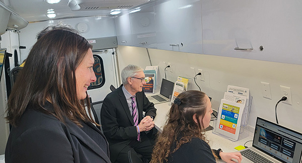 Department of Workforce Development (DWD) Division of Employment and Training Specialist Kim Silverling demos online tools for Gov. Evers and DWD Deputy Secretary Pam McGillivray on Feb. 29, 2024.