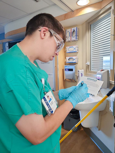 Holden Olstad cleaning hospital room